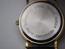 Close-up of the brushed stainless steel case back, engraved with 'STAINLESS STEEL BACK WATER RESISTANT 3ATM 012.200'.