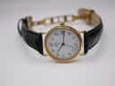 Three-quarter view of the Sewills watch, dial slightly angled, with the black leather strap open.