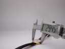 A digital caliper measuring the case diameter of the watch, displaying a precise reading of 29.45mm.