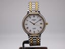 Front view of a Rotary 3705 two-tone quartz watch with a white Roman numeral dial and date window on a display stand.
