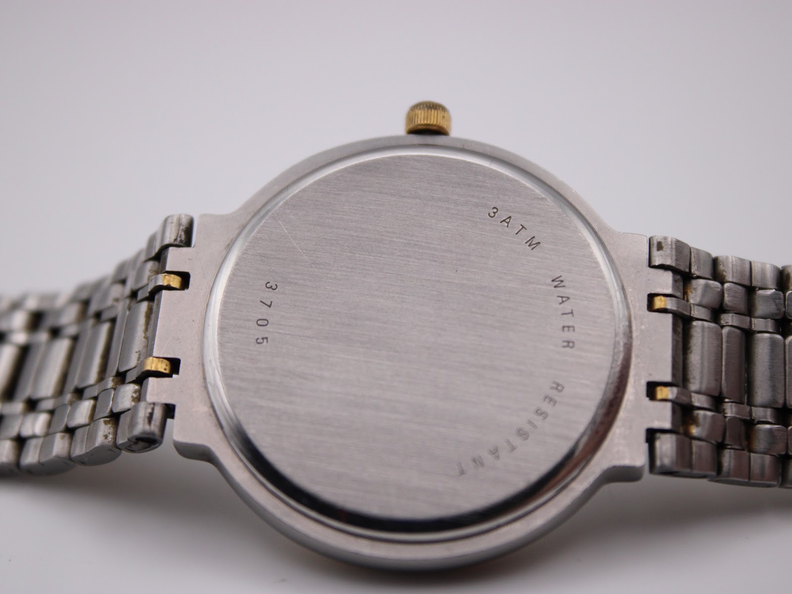 Close-up of the Rotary 3705 watch case back, showing '3 ATM WATER RESISTANT' and '3705' engravings.