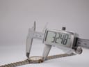 Digital caliper measuring the case diameter of the Rotary 3705 watch, displaying a precise measurement of 32.48mm.