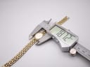 Digital caliper measuring the case diameter of the Citizen watch, displaying a precise reading of 18.72mm.