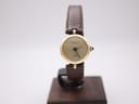 Front view of a rare vintage Gucci 2000L ladies' watch, featuring a gold plated case and champagne sunburst dial, on a display stand.