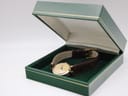 The Gucci 2000L watch resting open in a green non-original presentation box, showcasing the overall elegant presentation.