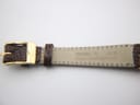 Close-up of the watch strap near the buckle, showing '13 MM R' and 'MADE IN SWITZERLAND' alongside the 'GUCCI' signed gold buckle.