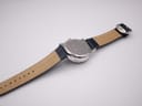 Back view of the Avon watch with the navy blue leather strap fully extended, showing the case back and the lighter underside of the strap.