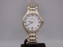 Front view of Maurice Lacroix les classiques two-tone watch with white dial, gold Roman numerals, and date window.