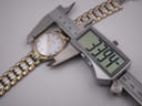 Digital caliper measuring the watch case diameter at 33.94mm, showing the two-tone bracelet.