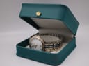 Maurice Lacroix les classiques watch resting in a teal presentation box.
