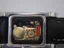 Close-up view of the Gucci 2300L quartz movement, showing the battery and internal components.