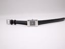 Top-down view of the Gucci 2300L watch laid flat, showing the full black leather strap and silver buckle.