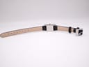 Bottom-up view of the Gucci 2300L watch laid flat, showing the cream underside of the genuine leather strap.