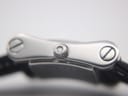 Close-up side view of the Gucci 2300L crown with the Gucci logo, and the screws securing the strap.