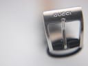 Close-up of the silver buckle for the Gucci 2300L, clearly showing the engraved 'GUCCI' logo.