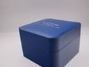 Top view of the closed original blue Rotary presentation box with the "Rotary Established in Switzerland 1895" logo embossed.
