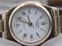 Detailed close-up of the white dial with clear black Roman numerals, a minute track, and "Rotary Quartz Swiss Made" text.