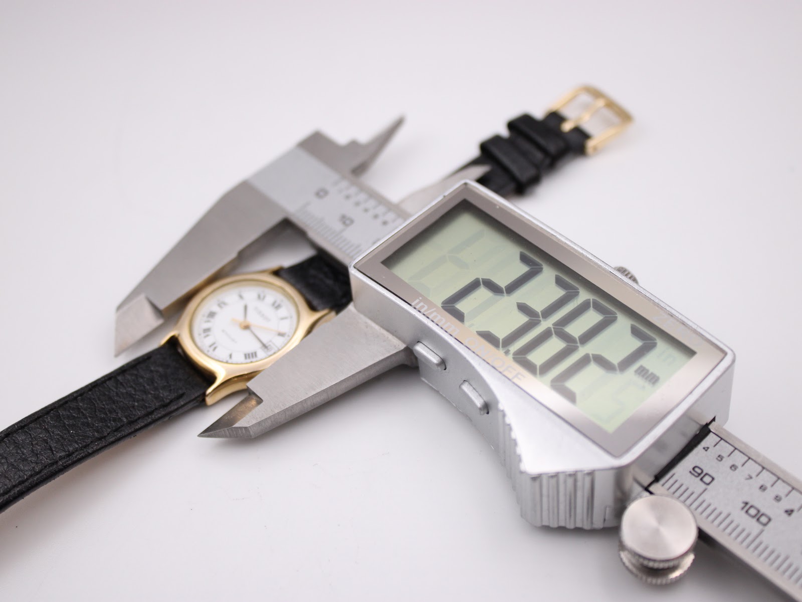 Digital caliper measuring the case diameter of the Tissot Stylist, showing 22.82mm on the display