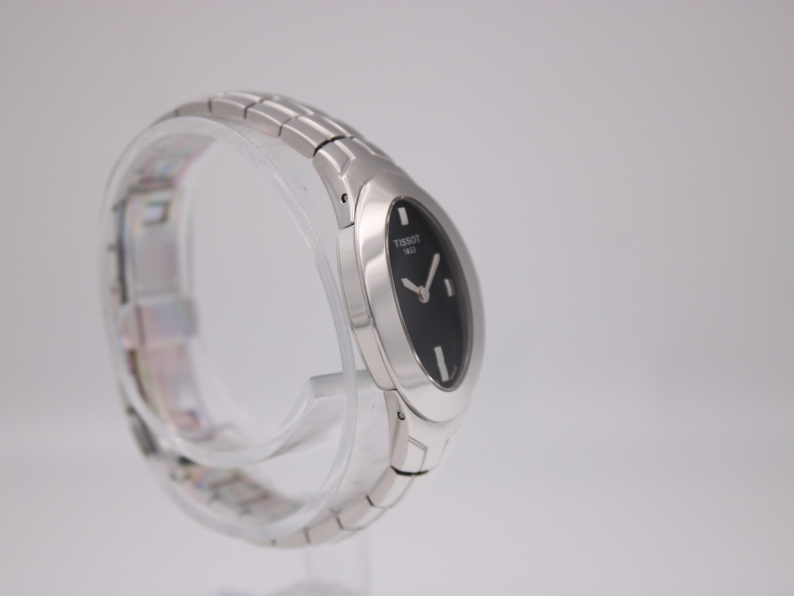 Angled side view of the Tissot L720, showcasing the elegant curve of the case and bracelet.