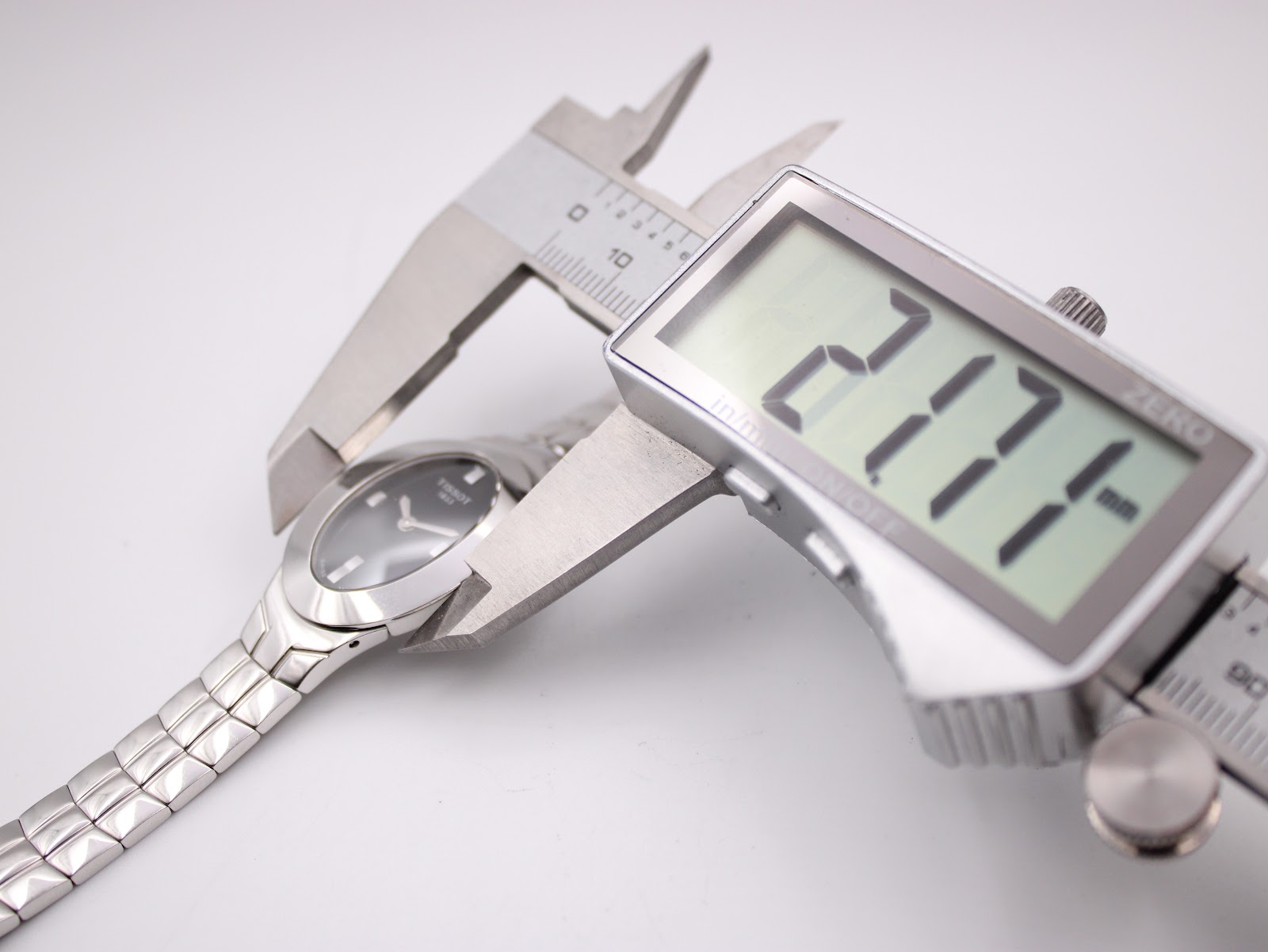 Digital caliper measuring the case width of the Tissot L720, displaying 21.74mm.
