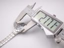Digital caliper measuring the case width of the Tissot L720, displaying 21.74mm.