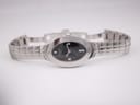 Full front view of the Tissot L720 watch laid flat, displaying the black oval dial and integrated stainless steel bracelet.