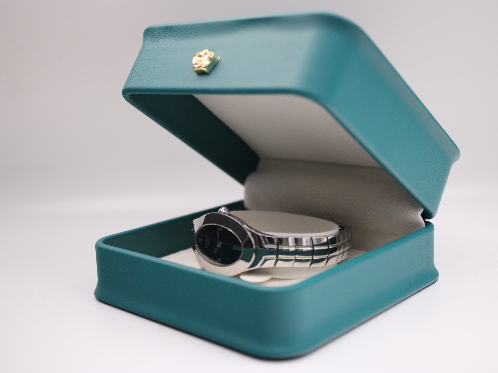 Tissot L720 watch presented in an open green gift box with a cream interior.