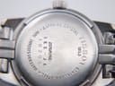 Close-up of the Tissot PR 50 stainless steel case back with model J326/426K, serial, 50m water resistant, and sapphire crystal engravings.
