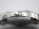 Close-up of the Tissot crown, clearly showing the 'T' logo against the polished case side.