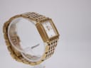 Another side view of the Tissot L910 watch on a clear stand, highlighting the case profile and bracelet links.