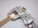 Digital caliper measuring the width of the Tissot L910 watch case, displaying a reading of 23.34mm.
