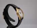 Left side view of the Tissot Seastar on a watch stand, highlighting the gold-plated case.