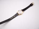 Back view of the Tissot Seastar watch laid flat, showing the 'REAL LEATHER' stamp on the strap.
