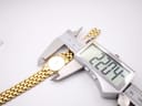 A digital caliper measuring the case diameter of the Gucci 3400L watch, displaying a precise measurement of 22.04mm.