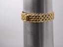 The gold plated multi-link bracelet of the Gucci watch wrapped around a metal wrist sizing gauge, indicating it fits a wrist of approximately 16cm.