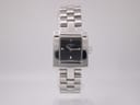 Front view of the Tissot T-Trend square ladies' watch, featuring a black dial and polished stainless steel brick-link bracelet on a plain background.