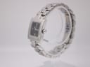 Right-side view of the Tissot T-Trend watch on a clear display stand, showing the polished stainless steel case and crown.