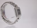 Left-side view of the Tissot T-Trend watch on a clear display stand, highlighting the integrated bracelet design and polished case.