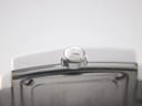 Macro shot of the polished stainless steel crown with the embossed Tissot "T" logo.