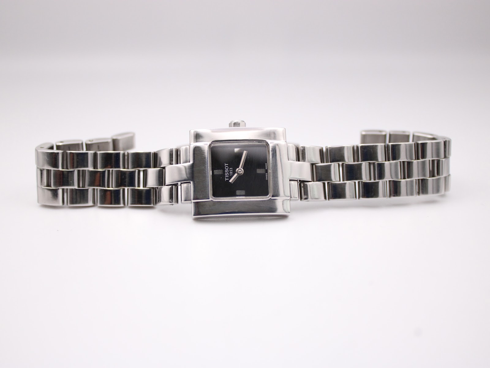 Overhead view of the Tissot T-Trend watch with its stainless steel bracelet laid flat, showcasing the full length of the design.