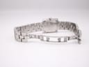 Close-up of the open hidden butterfly deployant clasp on the Tissot stainless steel bracelet, showing the "STAINLESS STEEL" engraving.