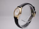 Angled side view of the Tissot F300 watch, showing the gold plated case and crown.