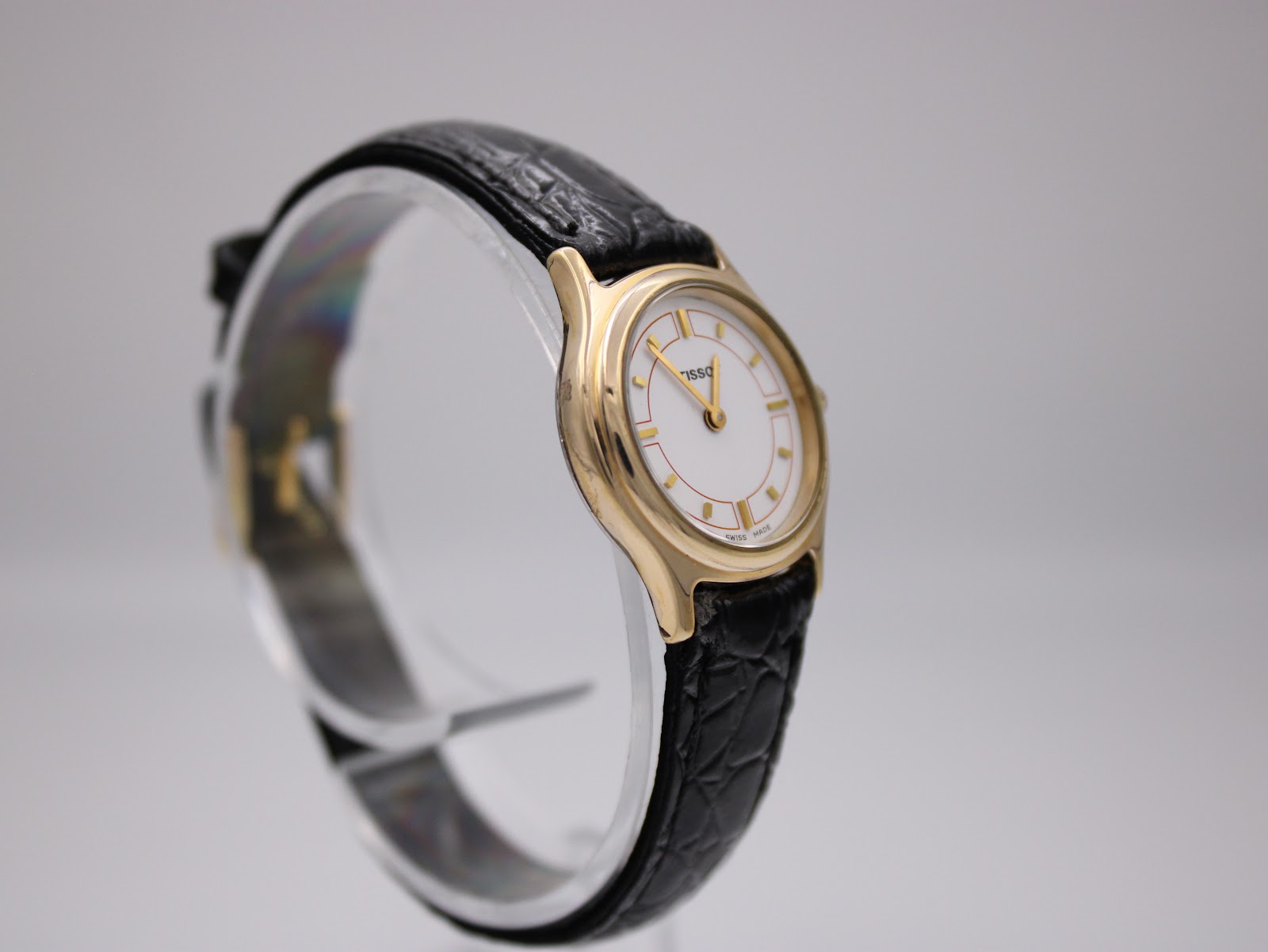 Another angled side view of the Tissot F300 watch, highlighting the white dial and strap texture.