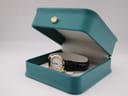 Tissot F300 watch displayed in an open teal presentation box with a gold crown emblem.