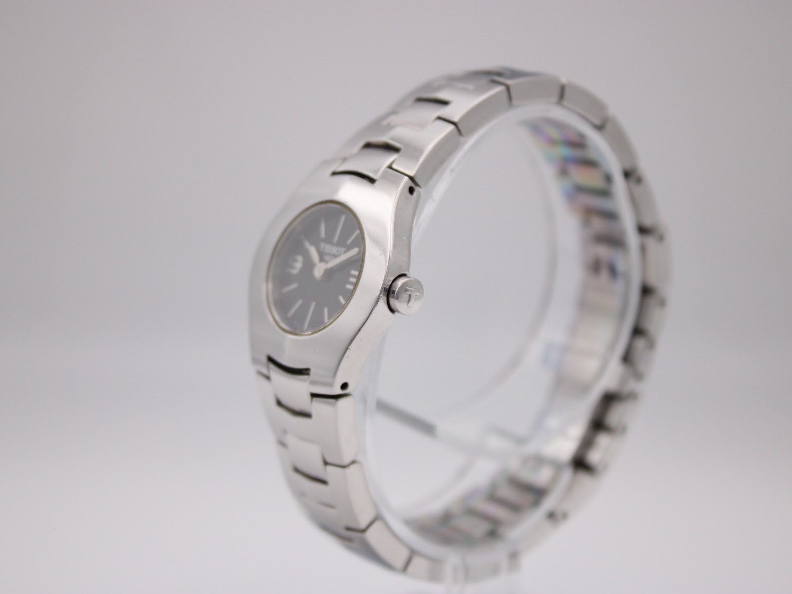 Angled side view of Tissot T-Trend watch showing the polished stainless steel case and integrated bracelet.