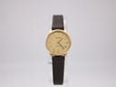 Front view of Tissot Stylist watch with champagne dial and dark brown leather strap.