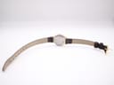 Back view of the Tissot watch showing the stainless steel case back and the full dark brown leather strap.