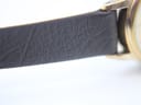 Close-up of the textured dark brown genuine calf leather strap.