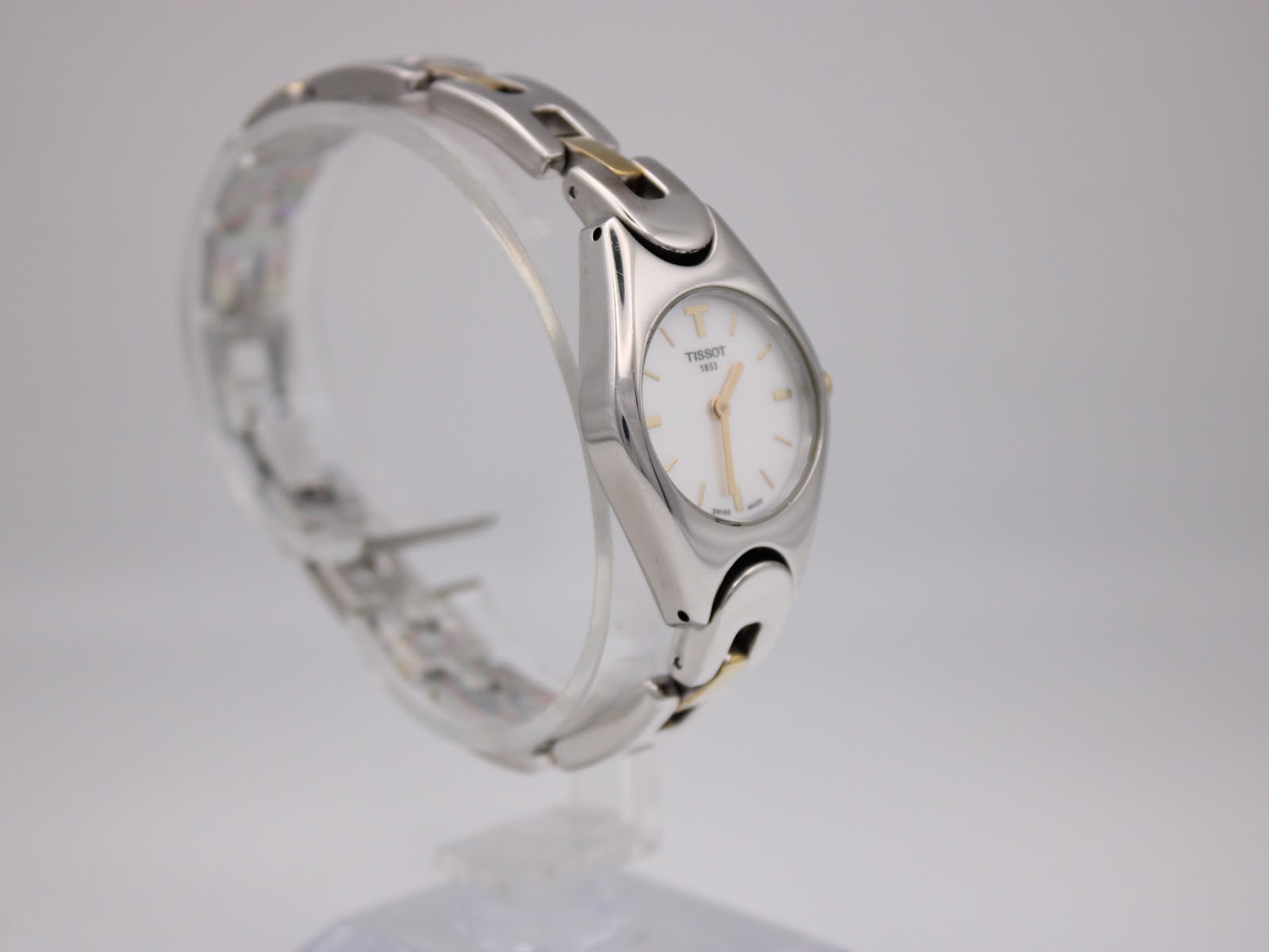 Angled view of the Tissot T-Trend watch, showcasing the two-tone stainless steel bracelet links and oval case shape.