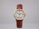 Front view of Junghans ladies' gold-tone watch with white dial, black Arabic numerals, and brown leather strap.